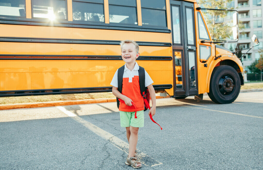 Picture of a kid walking away from a school bus